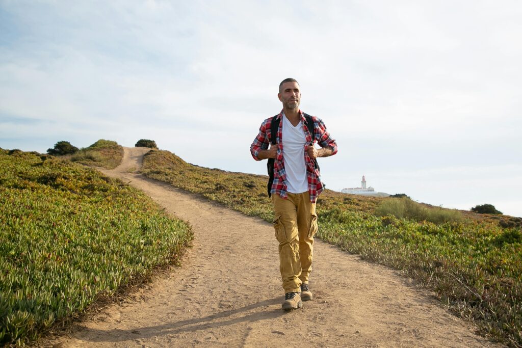 Man hiking on a scenic trail in Portugal, enjoying outdoor adventure and nature.