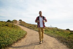 Man hiking on a scenic trail in Portugal, enjoying outdoor adventure and nature.